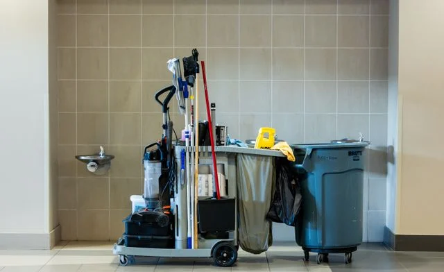 Janitorial cleaning equipment and supplies arranged for maintenance and sanitation tasks.